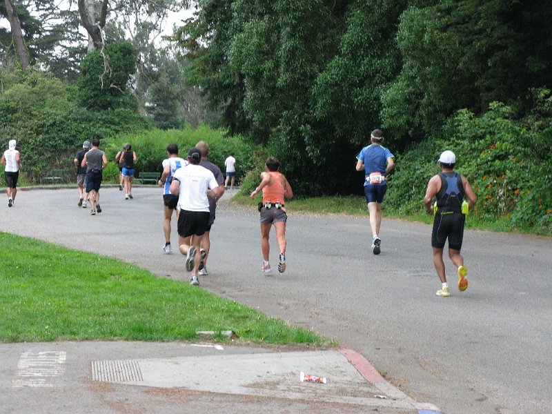 AlanPassesBy-mile17.JPG - Team Curry's fastest finisher, Alan was too quick for the cameraman. (Alan is in the white shirt and black hat.)
