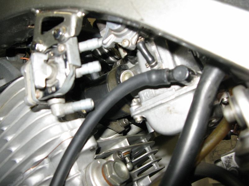 IMG_0116.JPG - The stock fuel tap takes two intake lines and has one output that is a bit low for this carb. Some work left to do there.