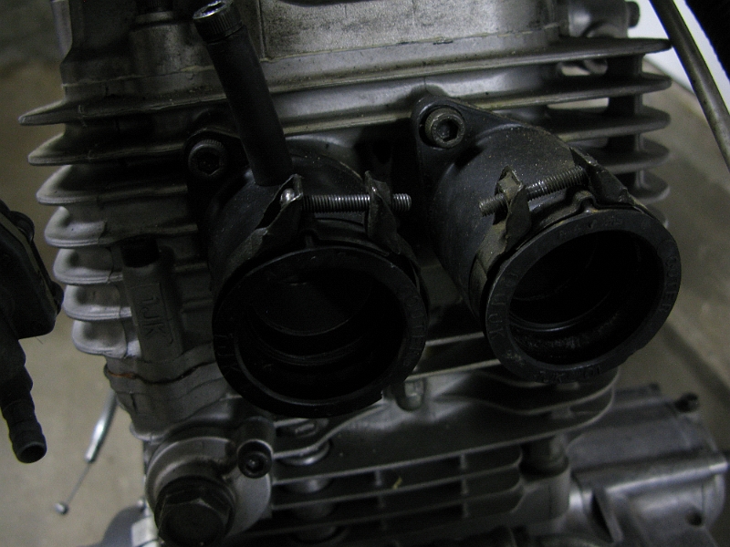 IMG_0154.JPG - The stock SRX boots were two different sizes. One of those sizes works with the EX250 carb. Use two of them on the head and you are in business.