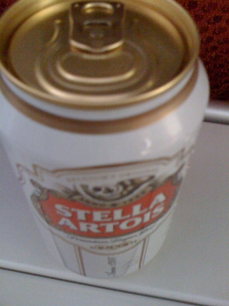 IMG_0010.jpg - Hoped in vain that this might help encourage a bit of sleep on the flight. Stella in a can always seems strange. Plus, here it is an imported premium beer, and in the UK one might here smart remarks about one getting in touch with one's inner wife beater if one were to order a Stella.