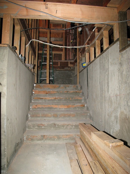 IMG_1763.JPG - That stud at the top of the stairs shows how deep the shelving on the left side will be. There will be a door on the right side.