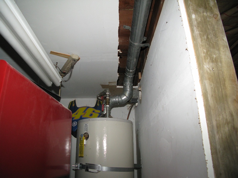 IMG_2142.JPG - Rerouted exhaust flue from the water heater. Still need to move the pressure relief water outlet pipe too.