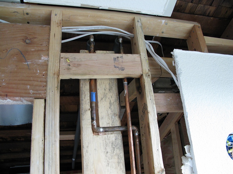 IMG_2157.JPG - Interesting bit of manual labor required to allow the water supply lines and the blocking for the shower door to coexist.
