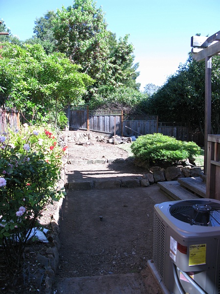 IMG_2319.JPG - Yesterday was cleanup day. Today is hardscape day. Stones were leftovers from the original landscaping.