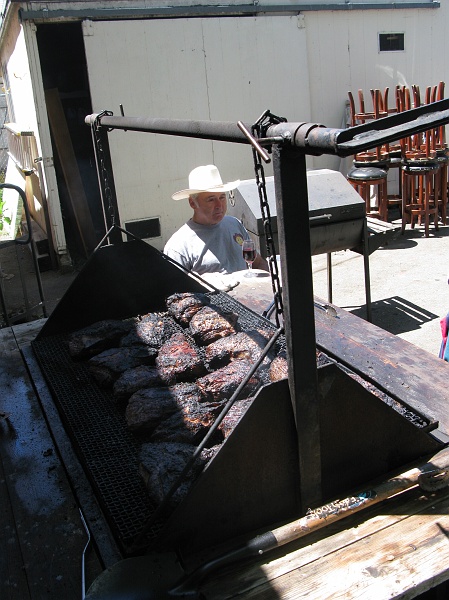 IMG_2493.JPG - The man in the zone, watching over the meat. The glass of wine just doesn't fit.